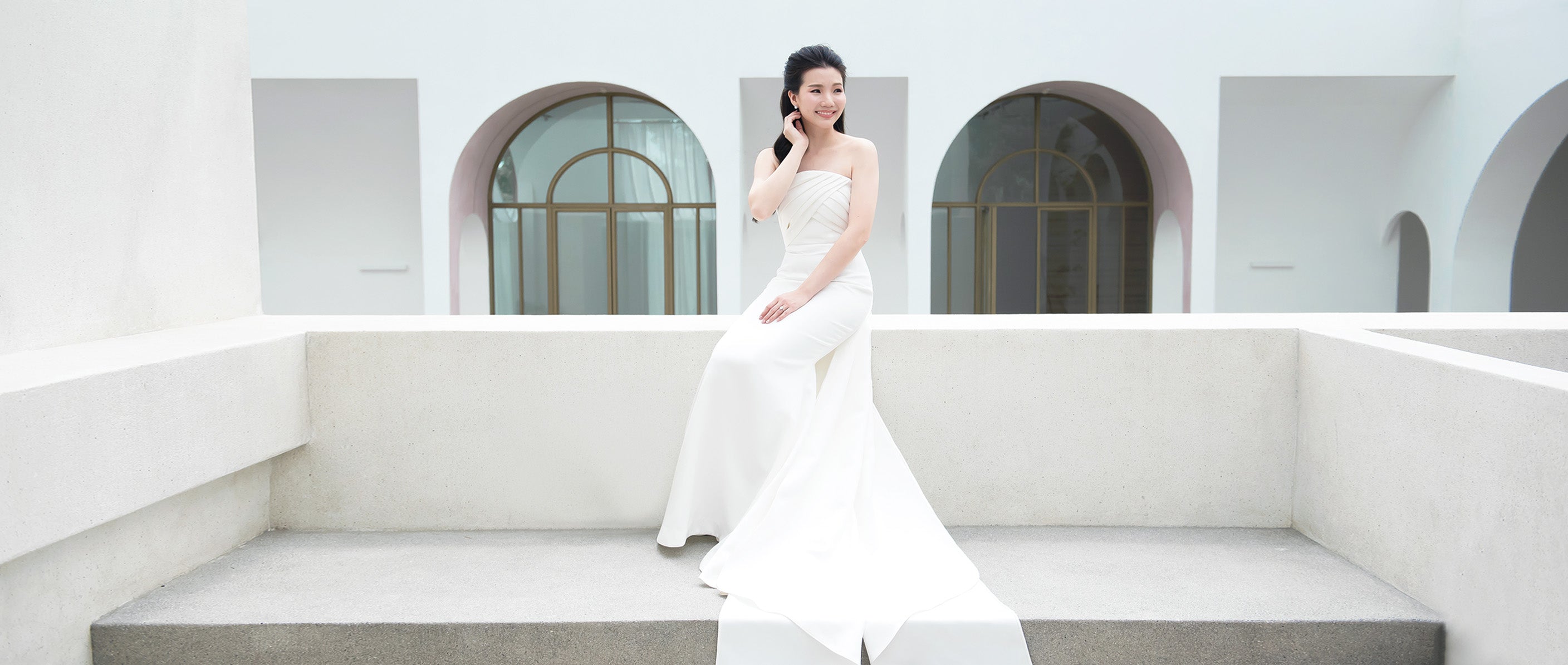 model wearing a white strapless minimal wedding gown