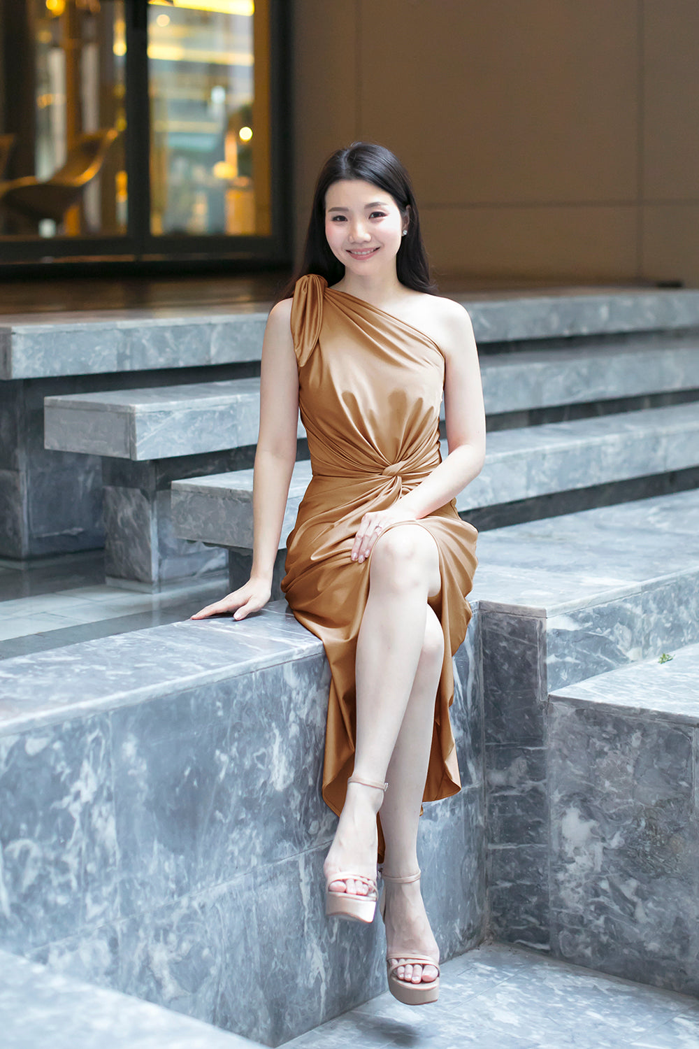 model in gold one-shoulder midi spandex evening dress