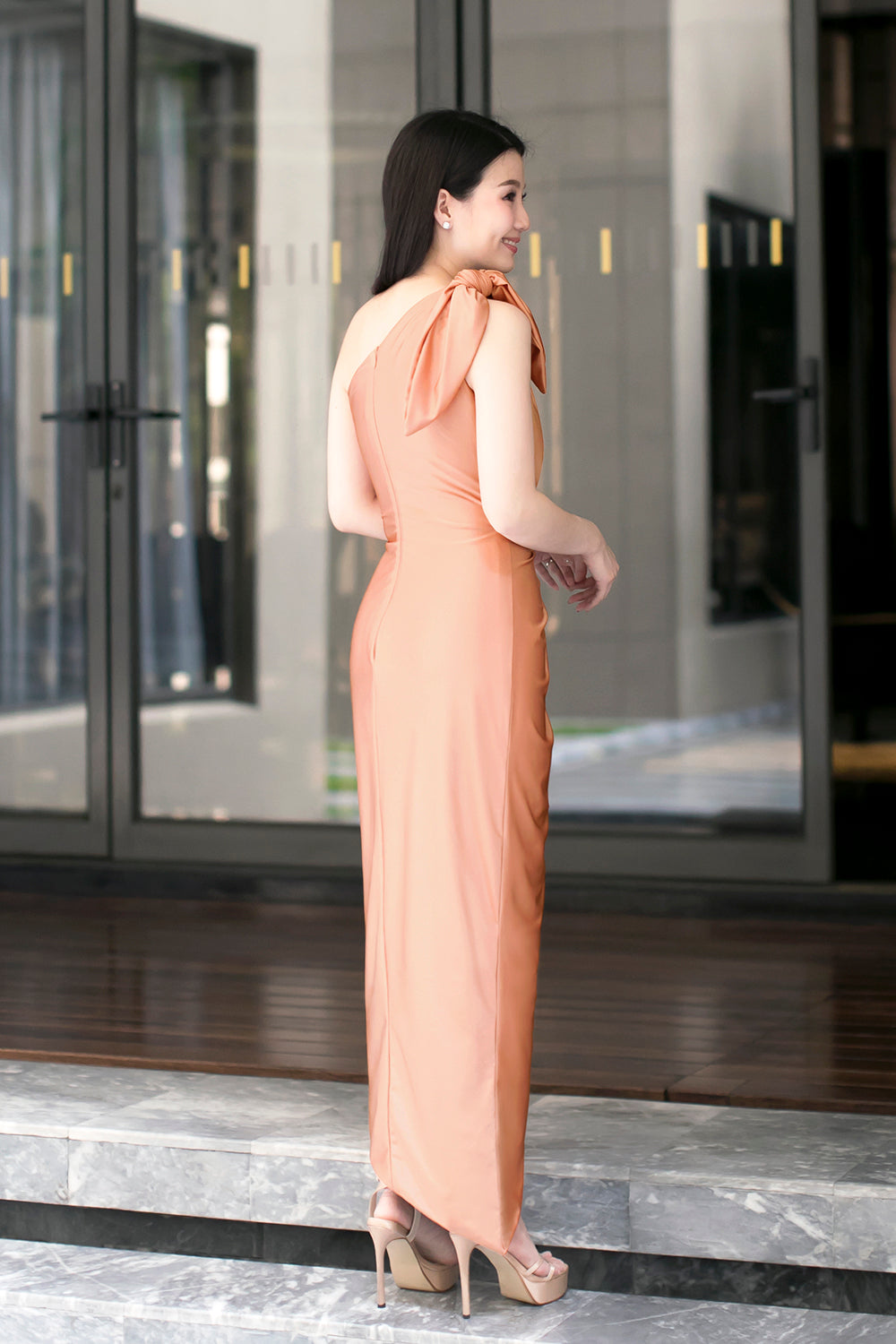 model in rose gold one-shoulder midi spandex evening dress