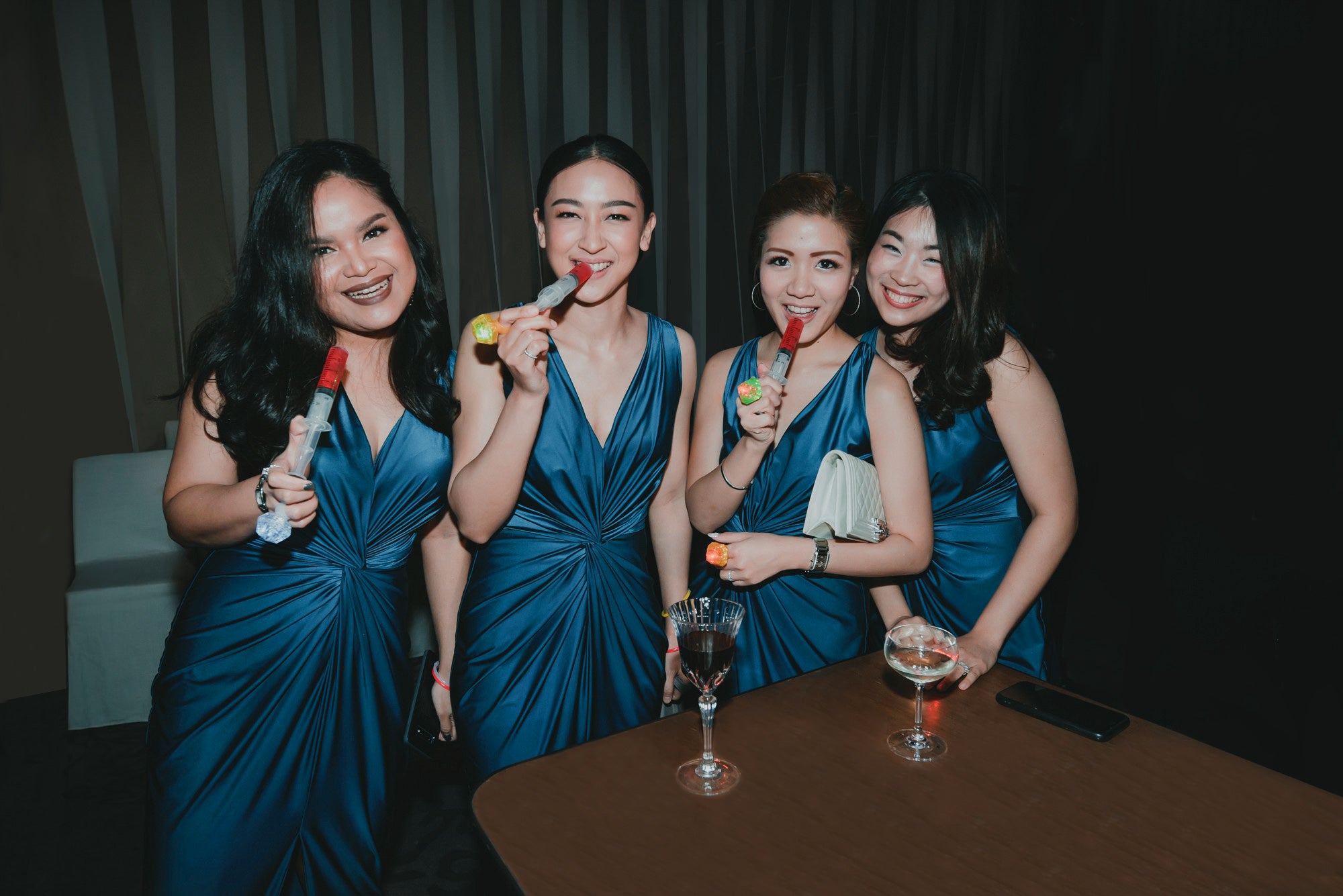 a group of bridesmaid wearing dark blue evening dresses