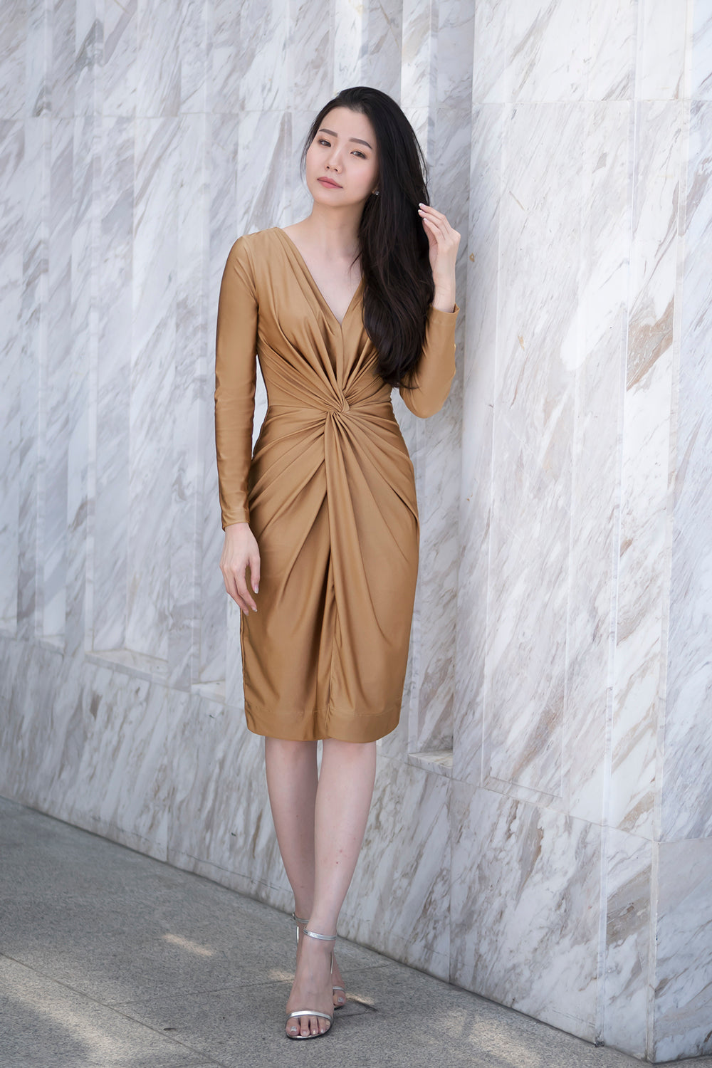 model in gold long sleeve v neck spandex event dress