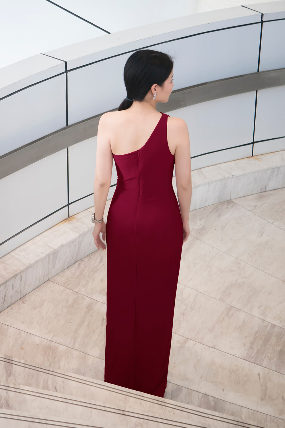 model in burgundy one shoulder spandex evening dress