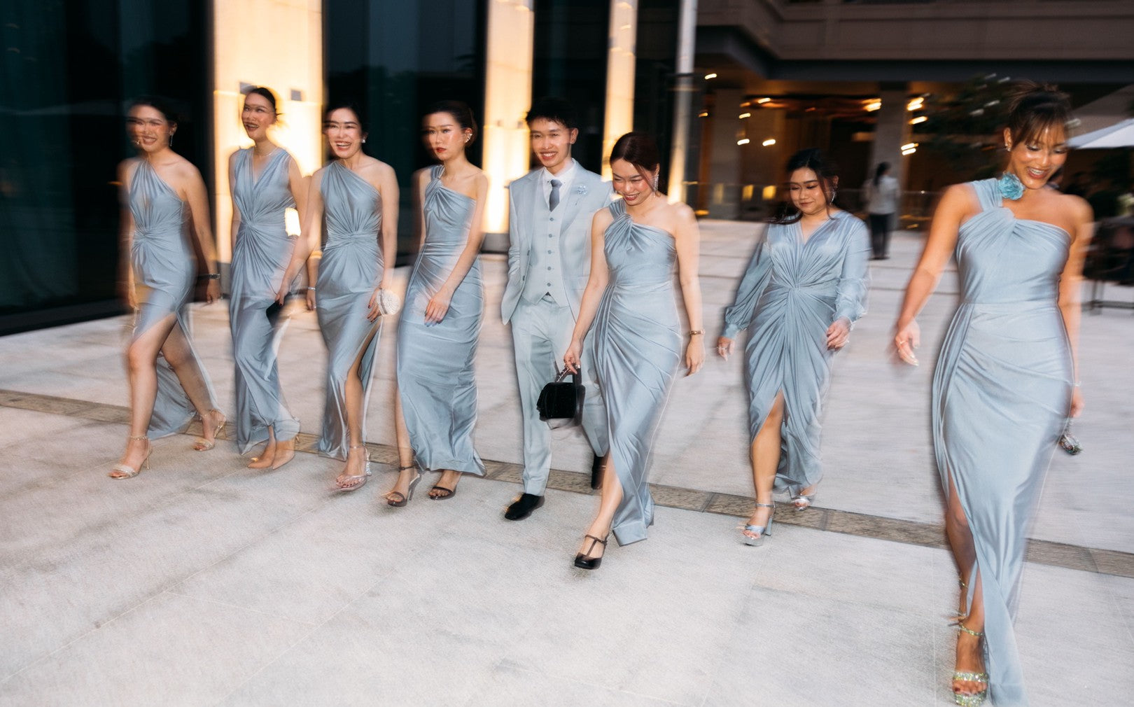 a group of bridesmaid wearing silver evening dresses