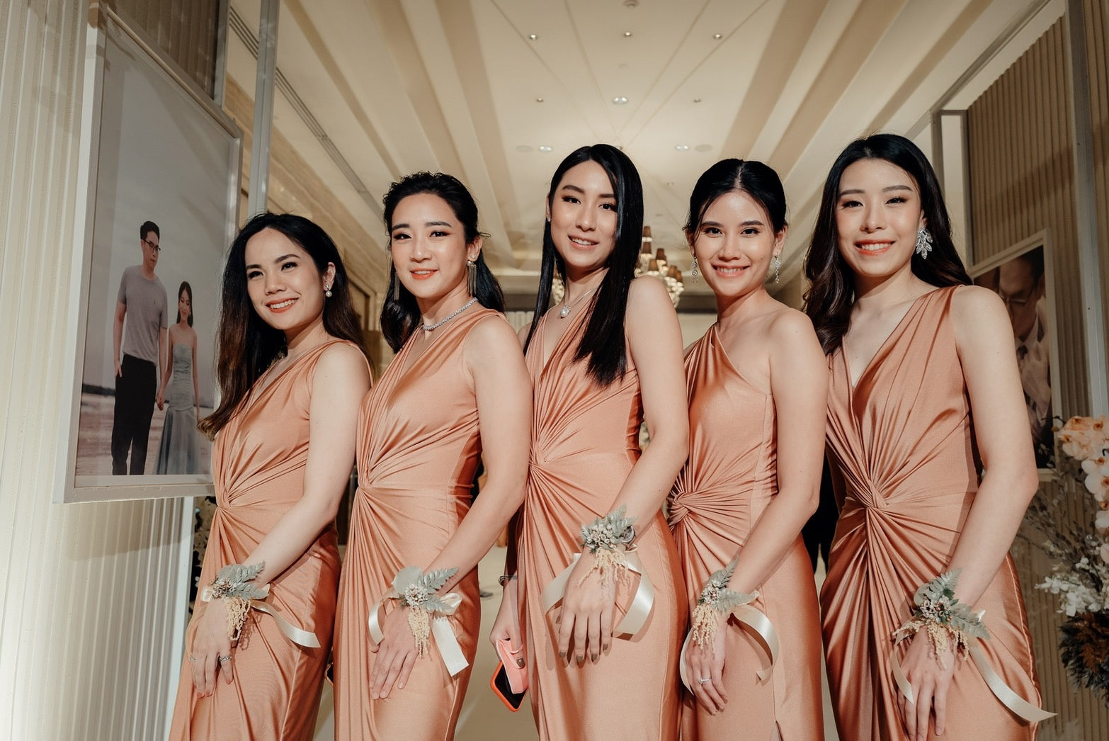 a group of bridesmaid wearing rose gold evening dresses