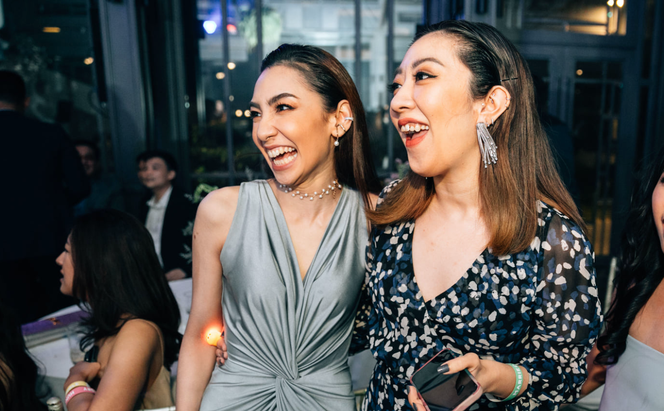 woman wearing a silver gray v neck wedding guest dress