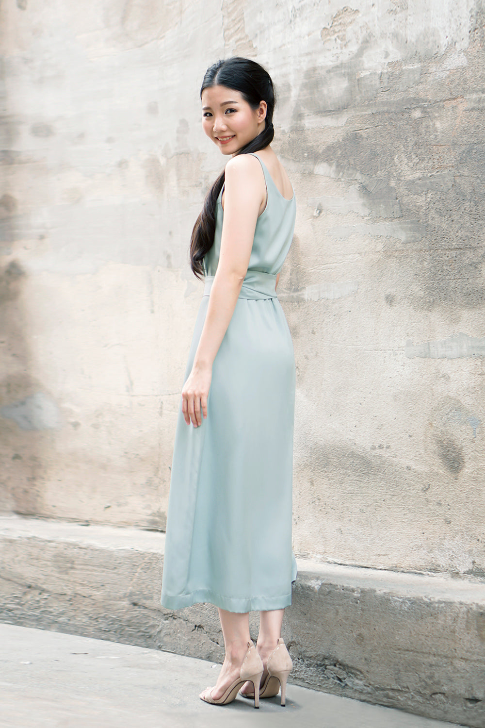 model wearing a muted teal casual v neck midi dress with dainty button detail