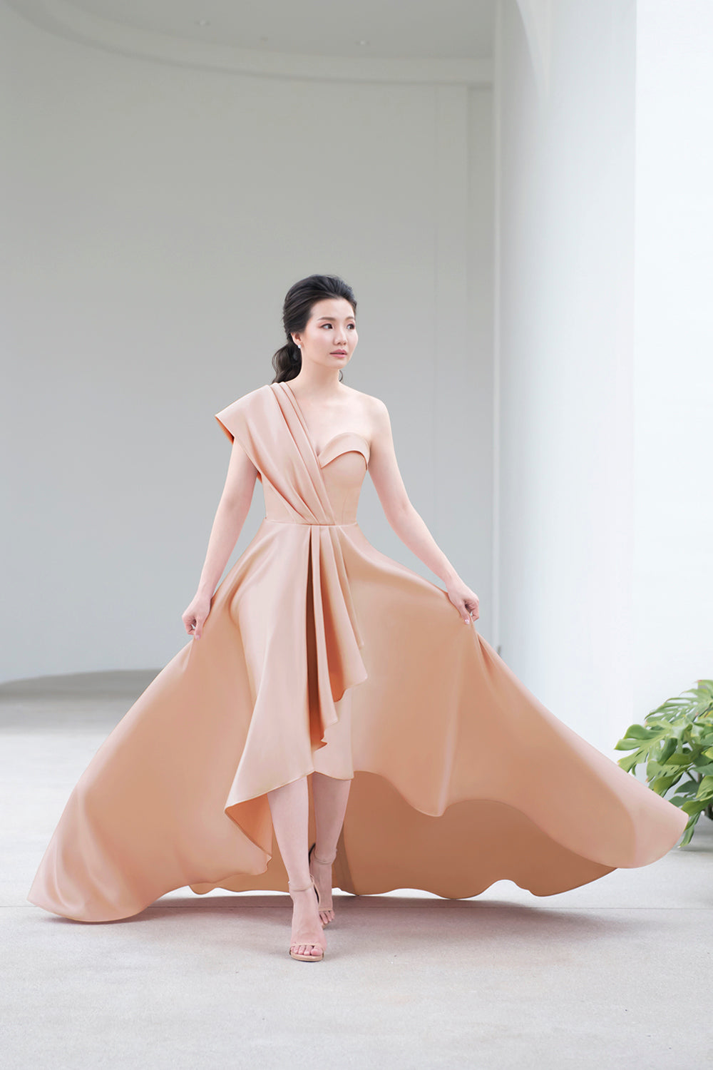 model wearing a sweetheart neckline minimal wedding gown in soft nude color