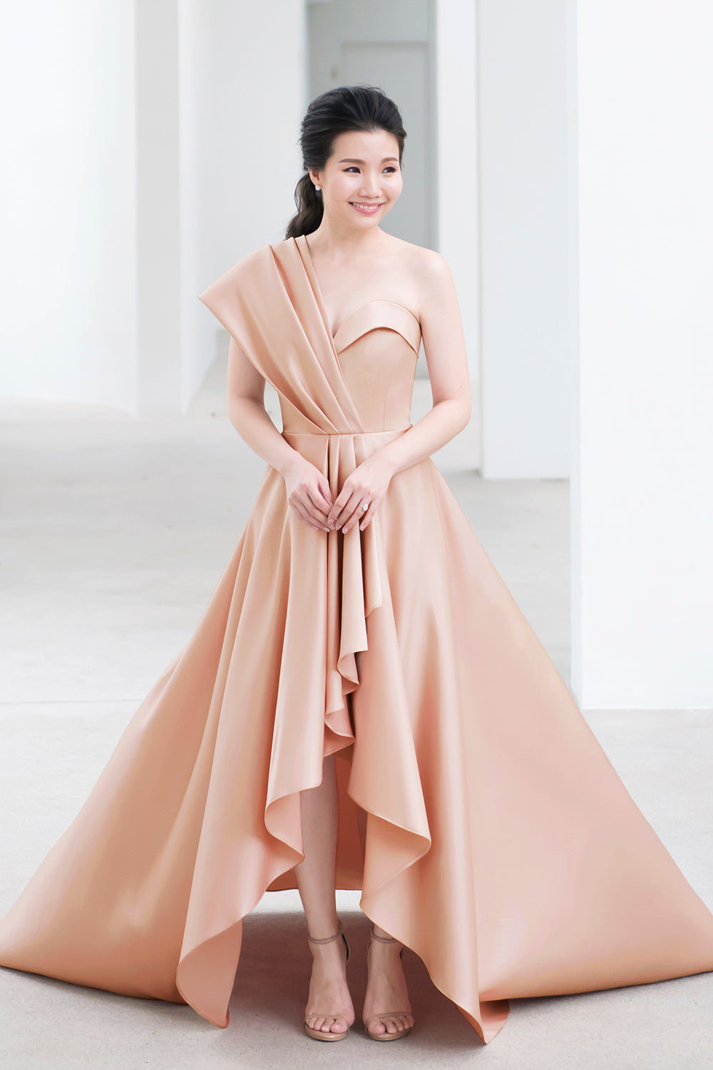 model wearing a sweetheart neckline minimal wedding gown in soft nude color