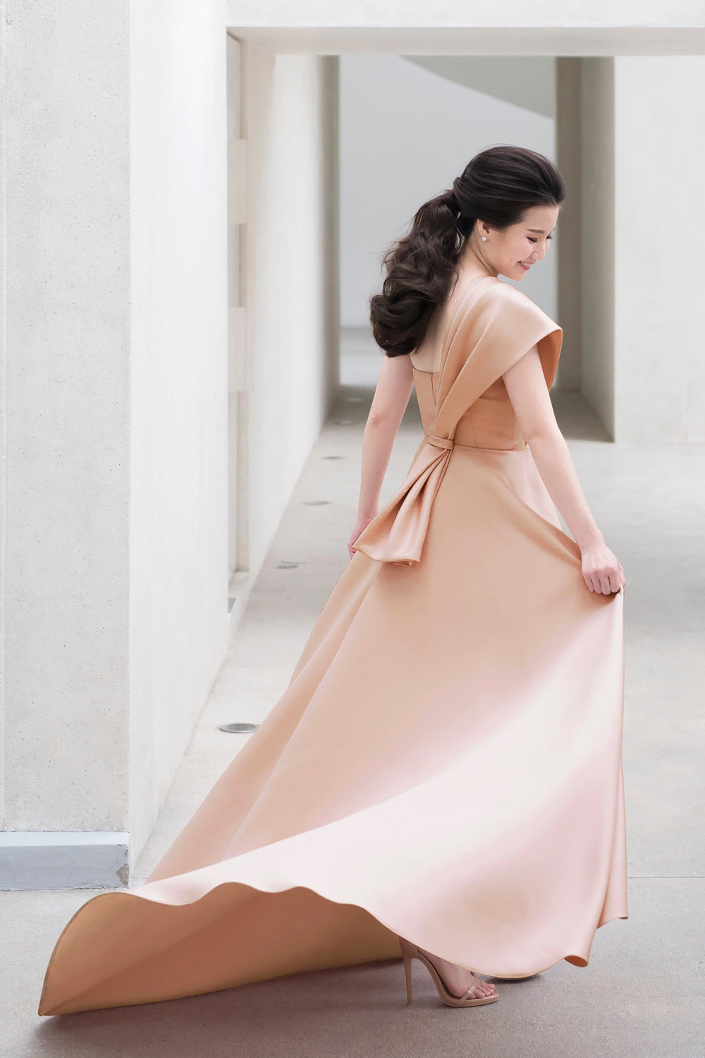 model wearing a sweetheart neckline minimal wedding gown in soft nude color