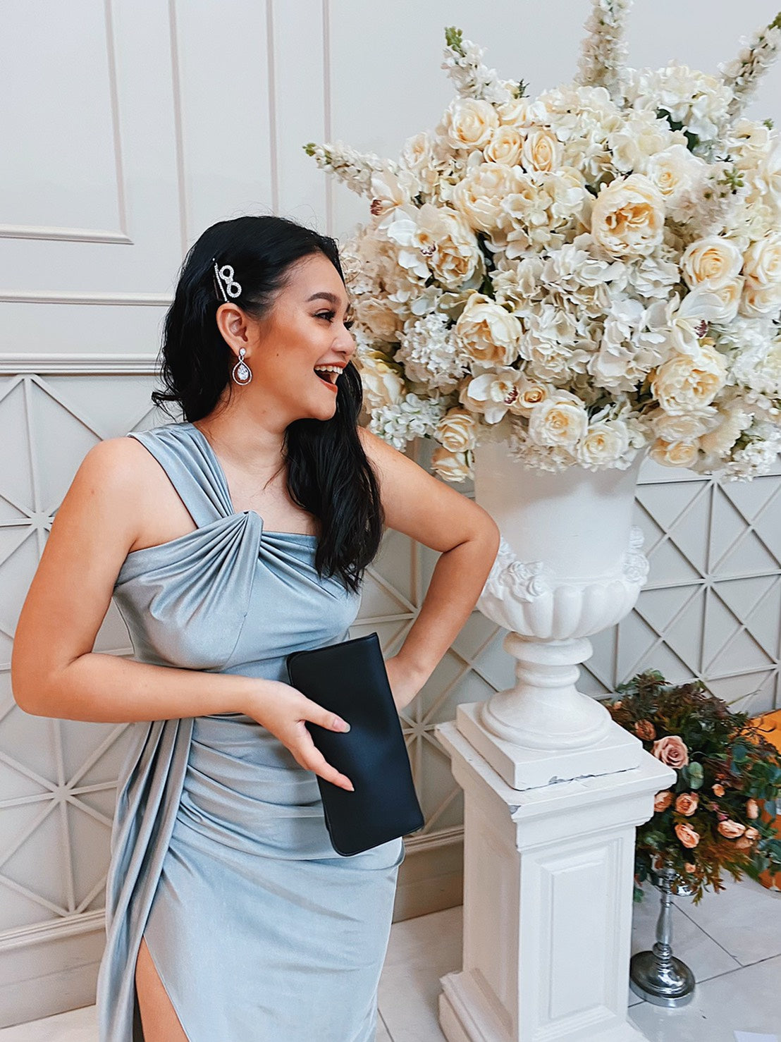 woman wearing a silver gray one shoulder evening dress