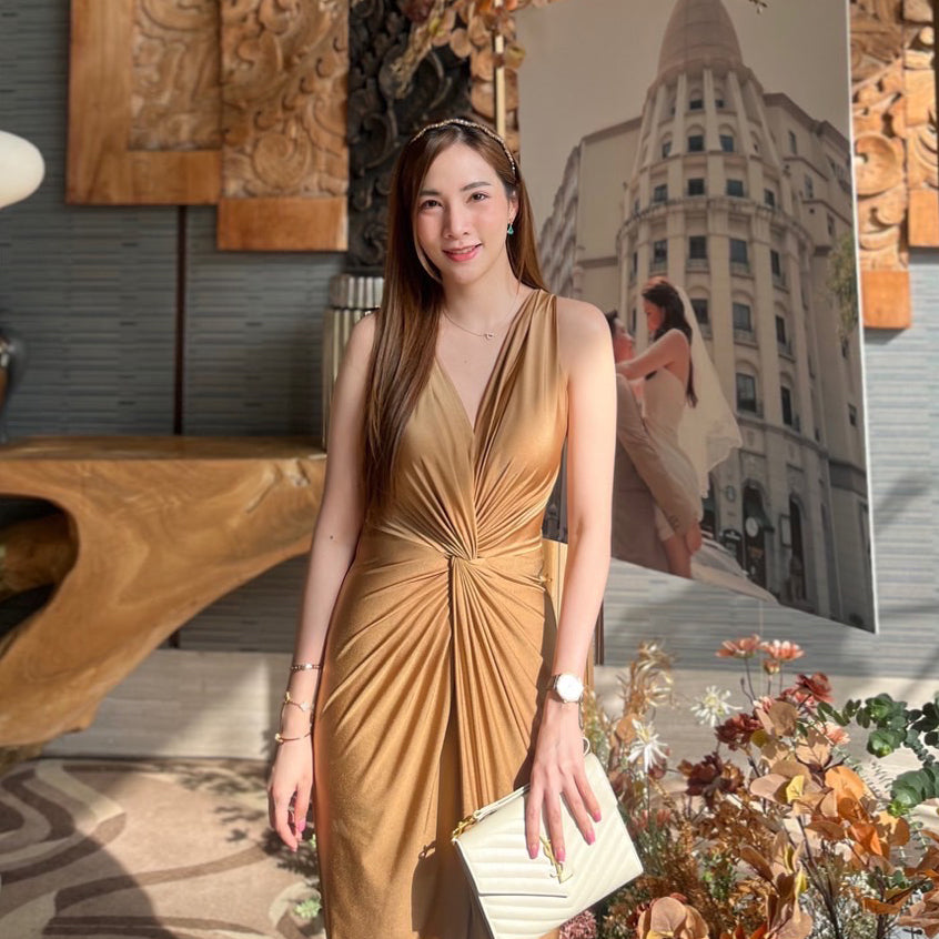 woman wearing a gold v neck formal dress