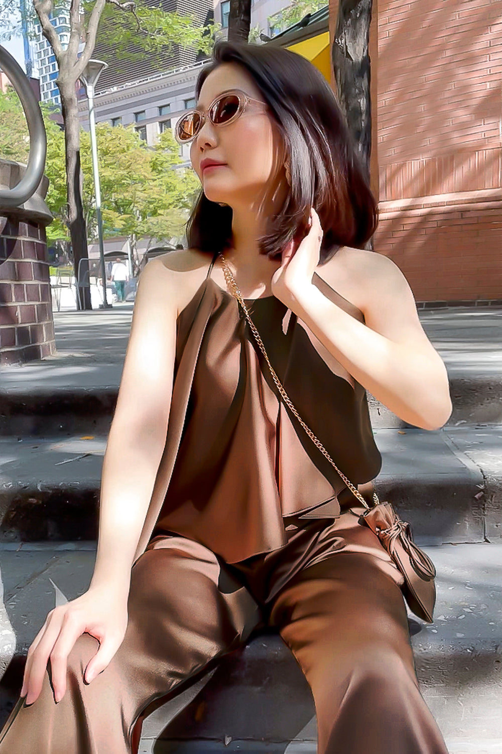 model wearing a brown halter neck top with matching high-waisted pants