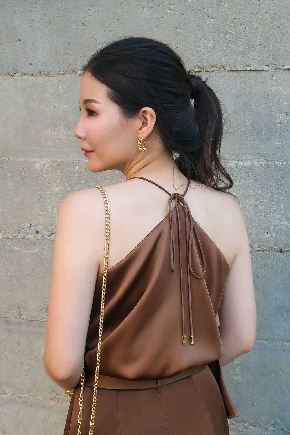 model wearing a brown halter neck top with matching high-waisted pants