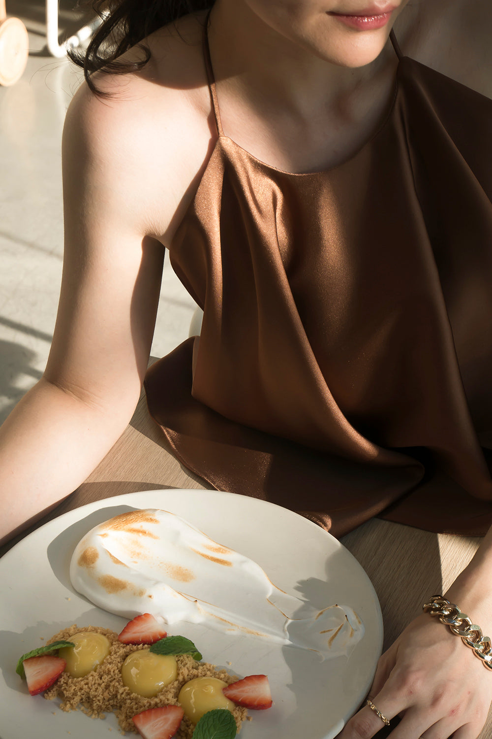 model wearing a brown halter neck top with matching high-waisted pants