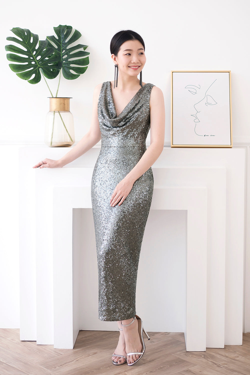 model wearing a glamorous midi open back dark gray sequin dress