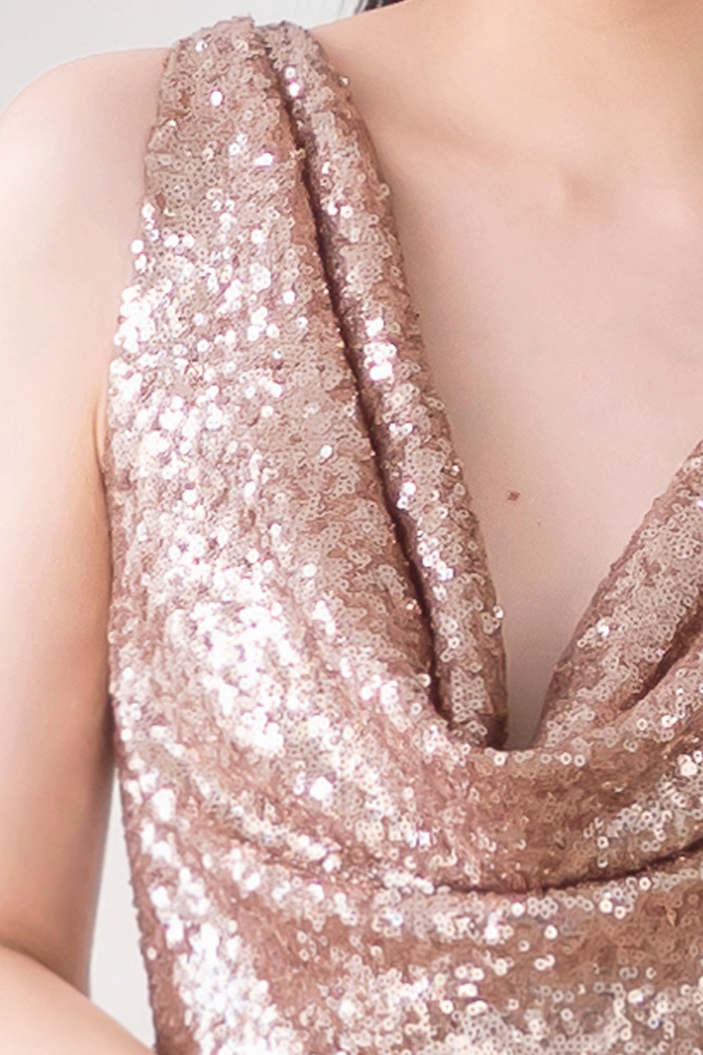 model wearing a glamorous midi open back rose gold sequin dress