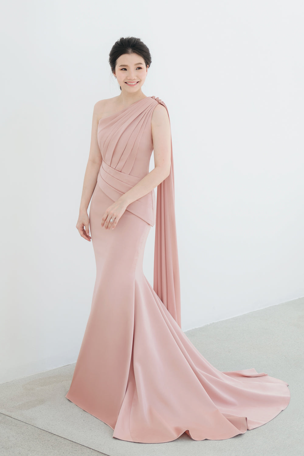 model wearing a one-shoulder two-piece set minimal wedding gown in nude pink color