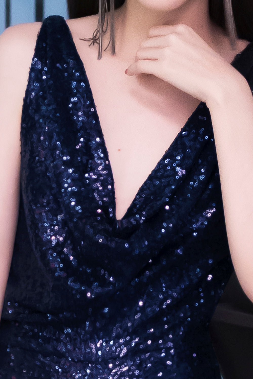 model wearing a glamorous open back navy sequin dress