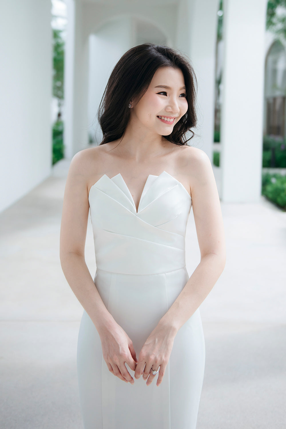 model wearing a white origami inspired strapless minimal wedding gown