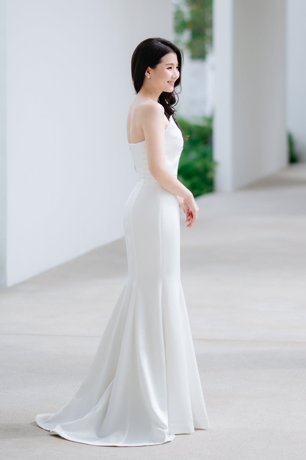 model wearing a white origami inspired strapless minimal wedding gown