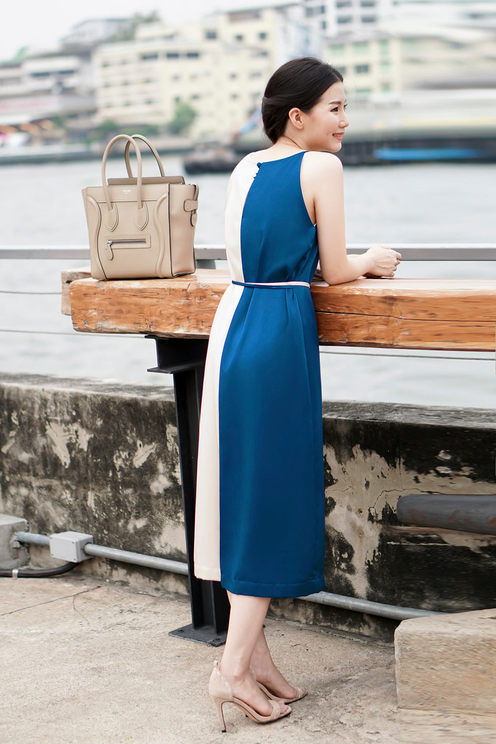 model wearing a blue cream color block casual dress