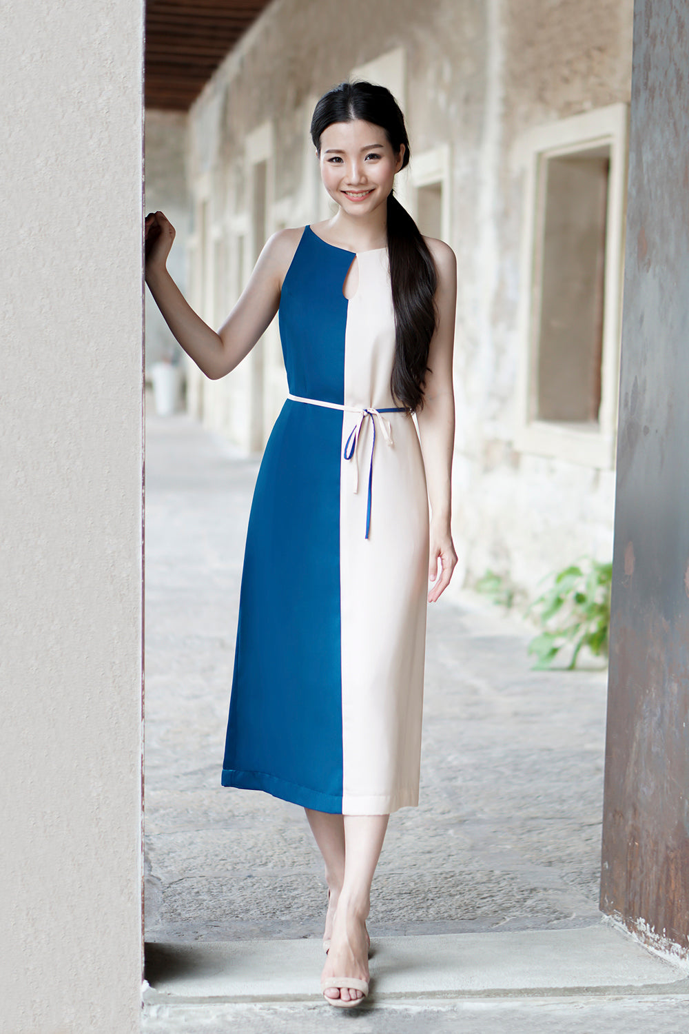 model wearing a blue cream color block summer dress