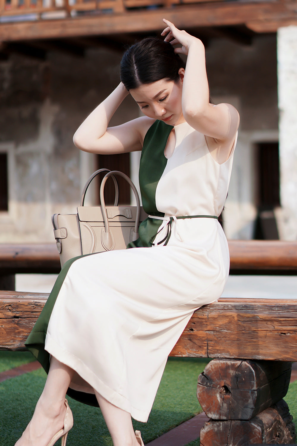 model wearing a green cream color block summer dress