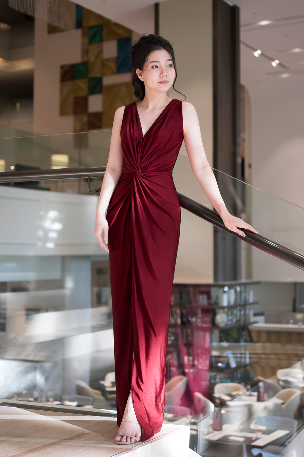 model in burgundy sleeveless v neck spandex event dress