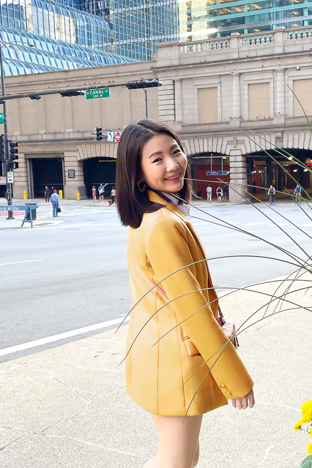 model wearing a yellow fitted silhouette blazer with a single button closure