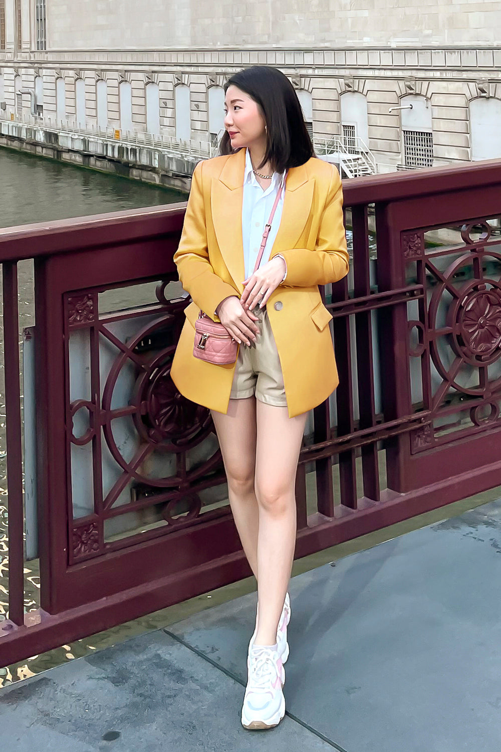 model wearing a yellow fitted silhouette blazer with a single button closure