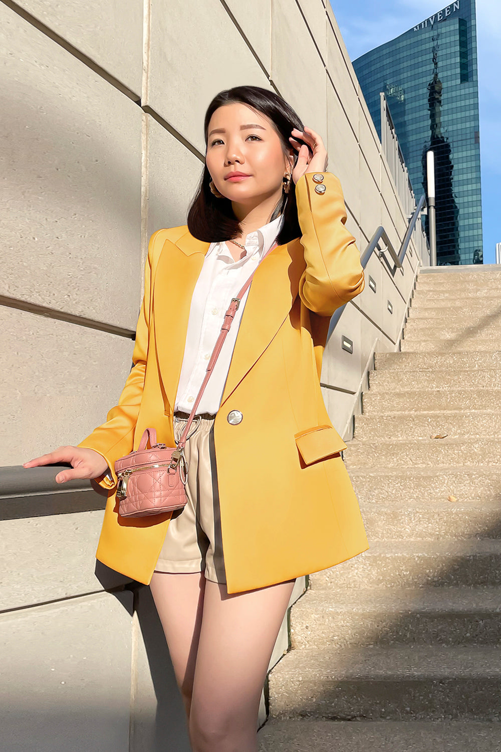 model wearing a yellow fitted silhouette blazer with a single button closure